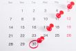 Calendrier avec punaises rouges : respecter le délai global de paiement d'un marché public